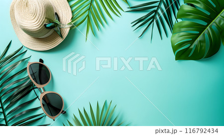 Hat, sunglasses, palm tree leaves on blue background. Blank, top view, still life, flat lay. Sea vacation travel concept tourism and resorts. Summer holidays. 116792434