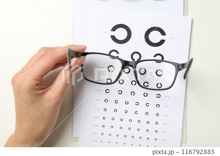 Glasses with a label for a paper vision test 116792883