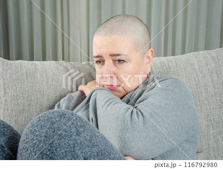 Woman with Cancer Contemplates Life Before Chemotherapy, Surrounded by Gray Ambiance. 116792980