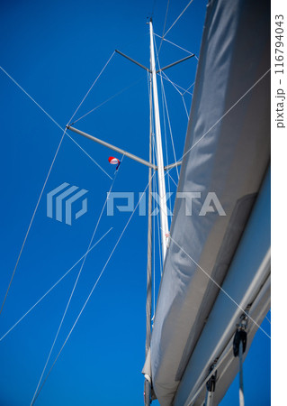 Yacht mast against a blue sky background Yacht mast against a blue sky background 116794043