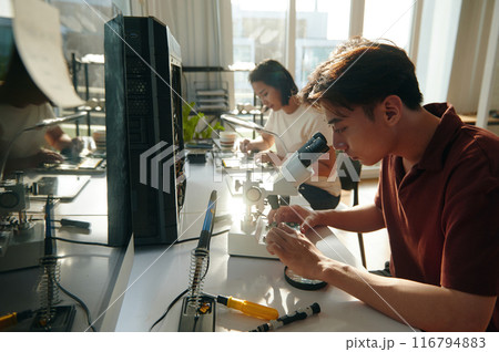 Repairman Using Microscope In Repair Repairman Using Microscope In Repair 116794883