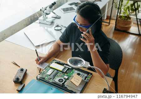 Master Making Notes During Repair 116794947