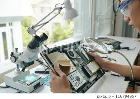 Technician Examining Details Of Laptop 116794957