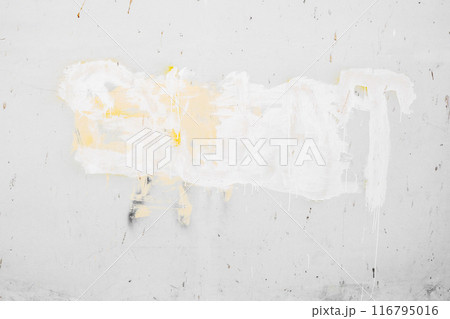 A wall with white paint and yellow paint splatters A wall with white paint and yellow paint splatters 116795016