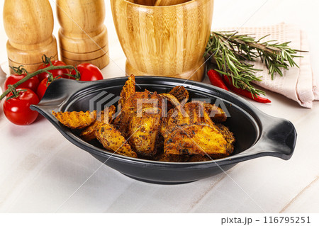 Golden baked potato Idaho with spices 116795251