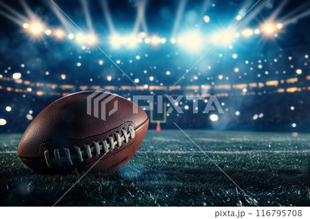 American football ball on field, stadium lights at night 116795708