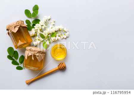honey jar with acacia flowers and leaves. fresh honey top view flat lay 116795954