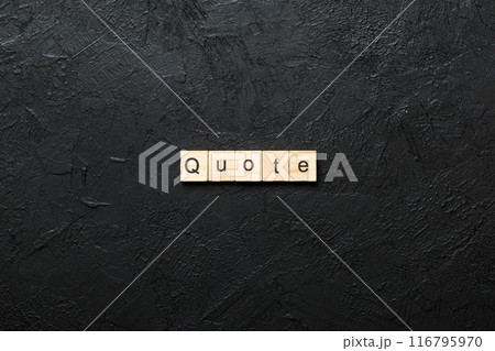 Quote word written on wood block. Quote text on cement table for your desing, concept 116795970
