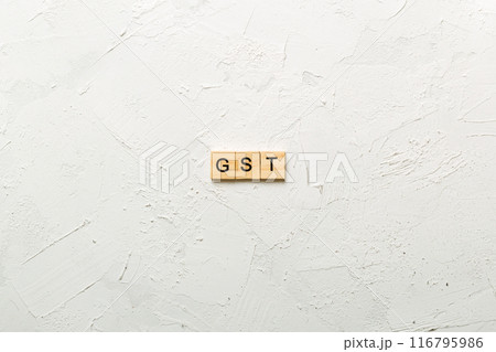 GST word written on wood block. GST text on cement table for your desing, concept 116795986
