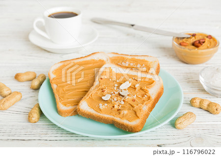 Peanut butter sandwiches or toasts on light table background.Breakfast. Vegetarian food. American cuisine top view vith copy space 116796022