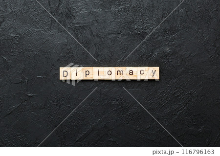 diplomacy word written on wood block. diplomacy text on cement table for your desing, concept 116796163