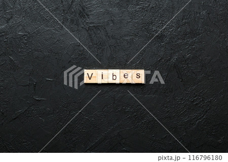 vibes word written on wood block. vibes text on table, concept 116796180