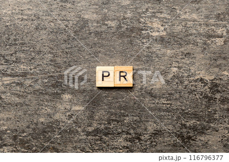 pr word written on wood block. public relation text on table, concept 116796377