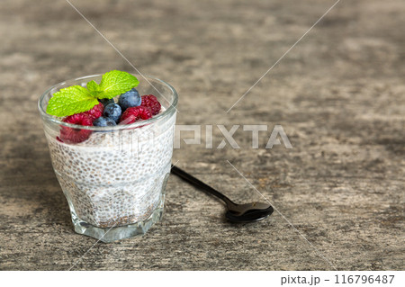 Healthy breakfast or morning with chia seeds vanilla pudding raspberry and blueberry berries on table background, vegetarian food, diet and health concept. Chia pudding with raspberry and blueberry Healthy breakfast or morning with chia seeds vanilla pudding raspberry and blueberry berries on table background, vegetarian food, diet and health concept. Chia pudding with raspberry and blueberry 116796487