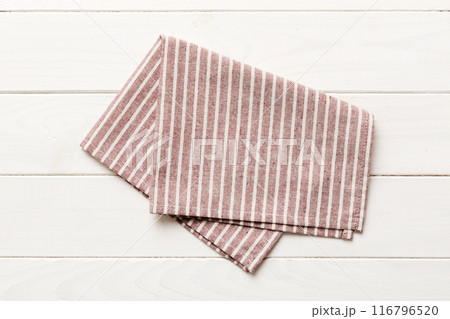 top view with red empty kitchen napkin isolated on table background. Folded cloth for mockup with copy space, Flat lay. Minimal style top view with red empty kitchen napkin isolated on table background. Folded cloth for mockup with copy space, Flat lay. Minimal style 116796520