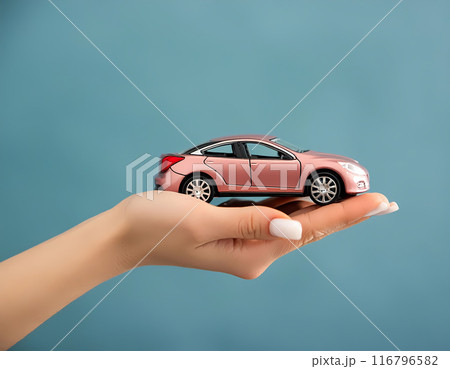 car in female hand isolated on teal background 116796582