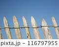 an old wooden gate with barbed wire 116797955
