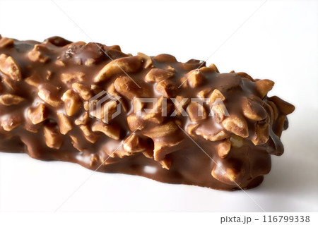 Fragment of chocolate wafer bar with caramel and peanuts isolated on white background Fragment of chocolate wafer bar with caramel and peanuts isolated on white background 116799338
