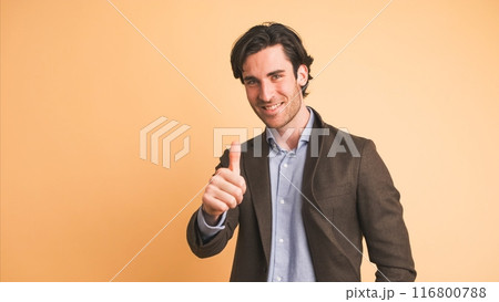 Happy businessman showing thumbs up in brown studio Happy businessman showing thumbs up in brown studio 116800788