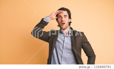 Stunned businessman with opened mouth in brown studio 116800791