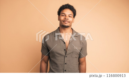 Positive man standing with satisfied expression on face 116800913