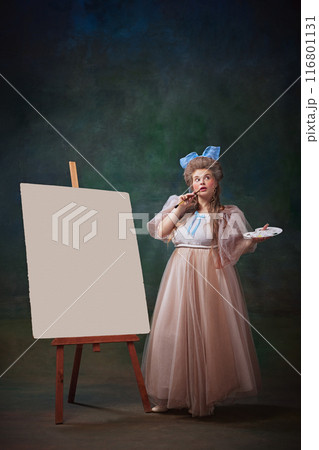 Creative Muse. Portrait of dreamy woman in historical gown with blue bow pondering before blank canvas with palette in hand. Art workshop, against vintage green background Creative Muse. Portrait of dreamy woman in historical gown with blue bow pondering before blank canvas with palette in hand. Art workshop, against vintage green background 116801131