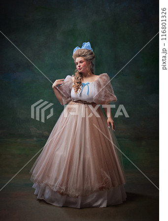 Portrait of beautiful young woman, medieval royal person on fancy dress and makeup, standing against vintage green background Portrait of beautiful young woman, medieval royal person on fancy dress and makeup, standing against vintage green background 116801326