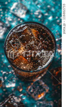 Glass of cola with ice cubes and condensation on turquoise background 116802733