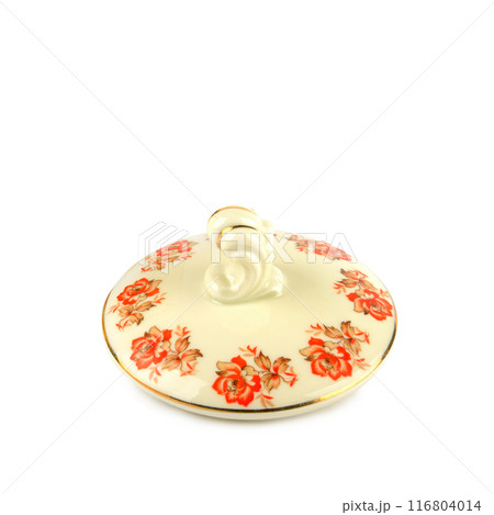 Porcelain lid from a sugar bowl with an elegant pattern isolated on a white. 116804014