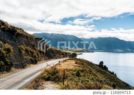 Scenic view lookout of the road cut through field and lake with mountain in autumn at New Zealand Scenic view lookout of the road cut through field and lake with mountain in autumn at New Zealand 116804713