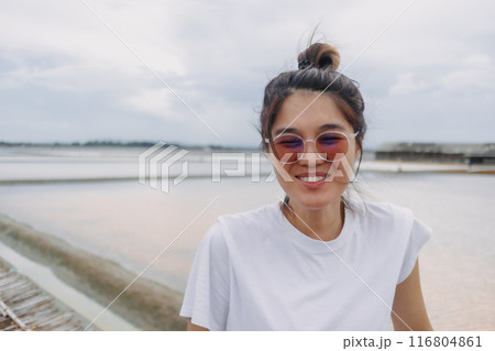 Outdoor portrait woman in white t-shirt and sunglasses. Real life act. 116804861