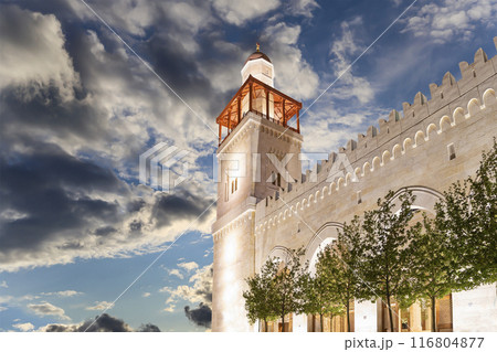 King Hussein Bin Talal mosque in Amman (at night), Jordan. Against the background of a beautiful sky with clouds King Hussein Bin Talal mosque in Amman (at night), Jordan. Against the background of a beautiful sky with clouds 116804877