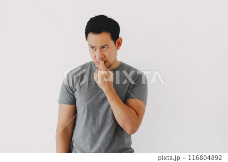 Sad and depressed humbly man in grey t-shirt isolated on white. 116804892