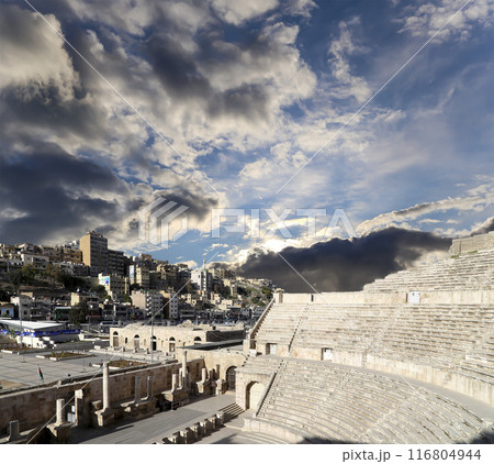 Roman Theatre in Amman, Jordan -- theatre was built the reign of Antonius Pius (138-161 CE), the large and steeply raked structure could seat about 6000 people. Against the sky with clouds Roman Theatre in Amman, Jordan -- theatre was built the reign of Antonius Pius (138-161 CE), the large and steeply raked structure could seat about 6000 people. Against the sky with clouds 116804944