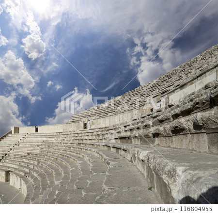 Roman Theatre in Amman, Jordan -- theatre was built the reign of Antonius Pius (138-161 CE), the large and steeply raked structure could seat about 6000 people. Against the sky with clouds 116804955