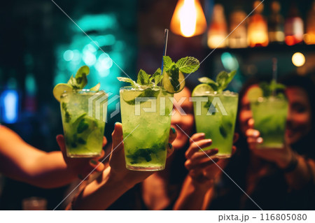 Vibrant photo of friends raising glasses of refreshing mojitos in a cozy bar ambiance 116805080