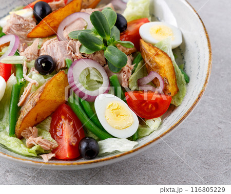 Salad with canned tuna, salad nicoise, on a gray background for a food delivery site menu 116805229