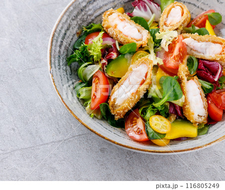 salad with panko shrimp, avocado and mango on a gray background for the restaurant menu, 116805249