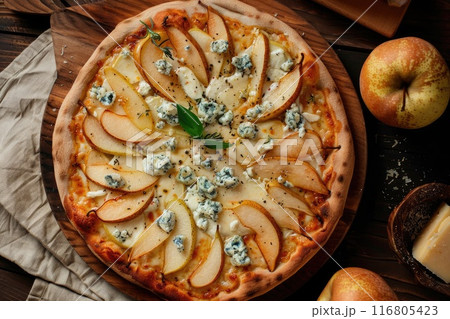 Gourmet Pear and Blue Cheese Pizza on Wooden Board with Basil Garnish 116805423