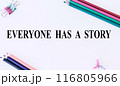 EVERYONE HAS A STORY text on white background and with pencils.The image shows a slogan Everyone Has a Story written on a white sheet. Bright picture. Concept Image 116805966