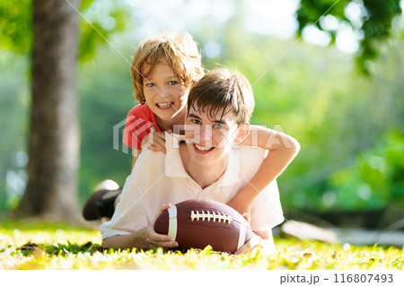 Family playing American football. Kids play rugby Family playing American football. Kids play rugby 116807493