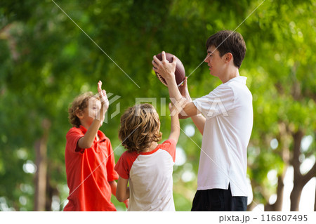 Family playing American football. Kids play rugby 116807495