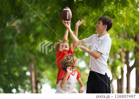 Family playing American football. Kids play rugby 116807497