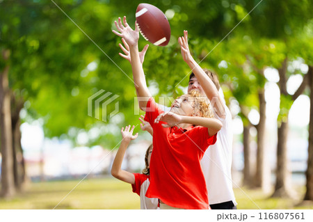 Family playing American football. Kids play rugby Family playing American football. Kids play rugby 116807561