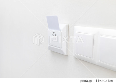 Hotel White Key Card Reader With Card For Powering Electricity. Hotel Key Card On Main Switch To Enable The Electric Circuit In Hotel Rooms. Horizontal Plane. Copy Space. Energy Saving Hotel White Key Card Reader With Card For Powering Electricity. Hotel Key Card On Main Switch To Enable The Electric Circuit In Hotel Rooms. Horizontal Plane. Copy Space. Energy Saving 116808186