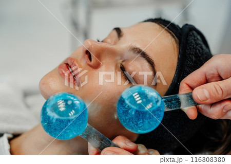 The master gives the client a relaxing facial massage using cold cryo spheres. 116808380