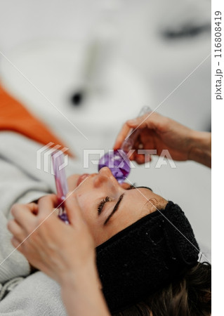 The master gives the client a relaxing facial massage using cold cryo spheres. 116808419