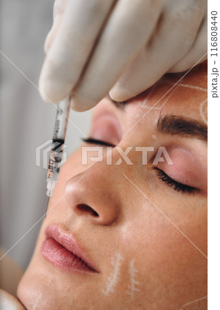 A woman gets injections in the face. 116808440