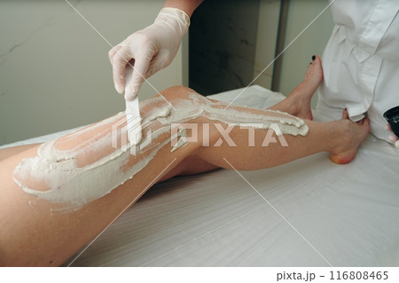 A woman receives a foot massage with peeling. 116808465