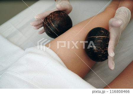 A woman gets a foot massage in a beauty salon. A woman gets a foot massage in a beauty salon. 116808466